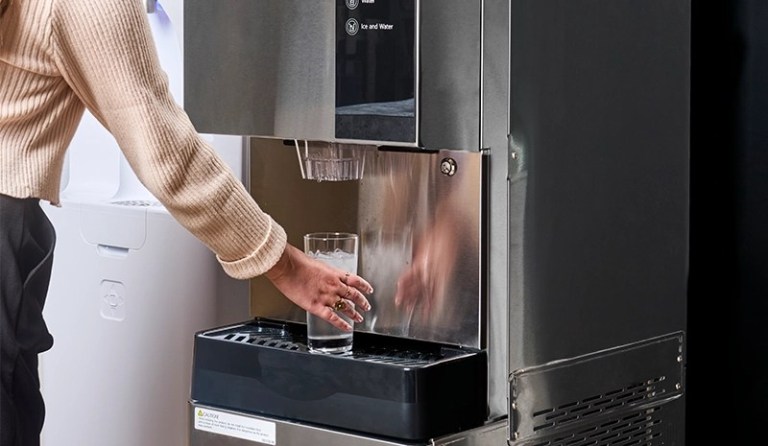 woman dispensing water from the 980-30 ice and water dispenser