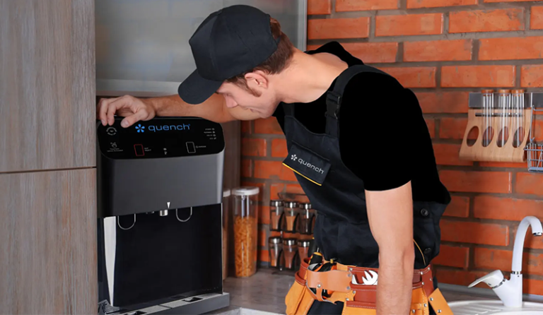 Culligan Quench service tech leaning on the Q8 countertop bottleless water cooler