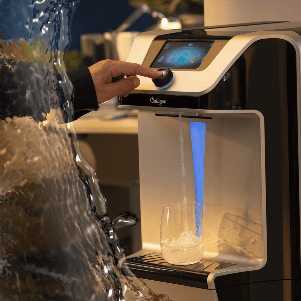 Hand dispensing Q10 countertop water cooler with splash coming in from the left